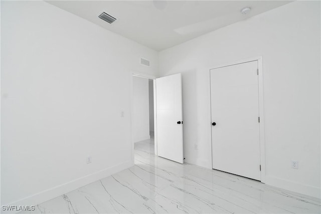 7071 Tide Cir, Labelle, FL 33935 - unfurnished bedroom featuring light marble finish flooring and baseboards