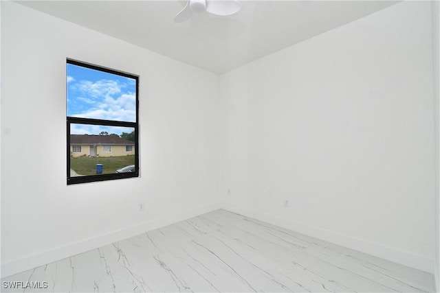 7071 Tide Cir, Labelle, FL 33935 - unfurnished room with light marble finish floors, baseboards, and a ceiling fan