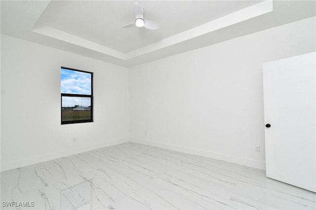 7071 Tide Cir, Labelle, FL 33935 - spare room with a raised ceiling, marble look tiles, and baseboards