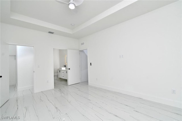 7071 Tide Cir, Labelle, FL 33935 - spare room with baseboards, light marble finish flooring, a ceiling fan, and a tray ceiling
