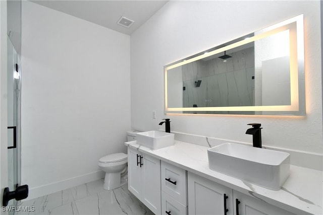 7071 Tide Cir, Labelle, FL 33935 - bathroom featuring a marble finish shower, marble look tile flooring, toilet, double vanity, and baseboards