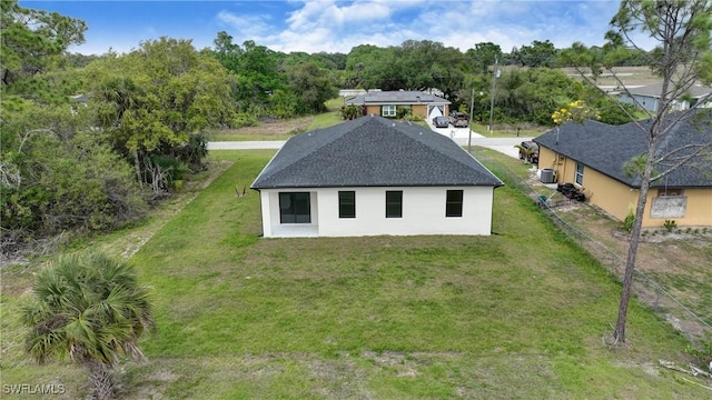 6010 Acorn Cir, Labelle, FL 33935 - rear view of house with stucco siding and roof with shingles