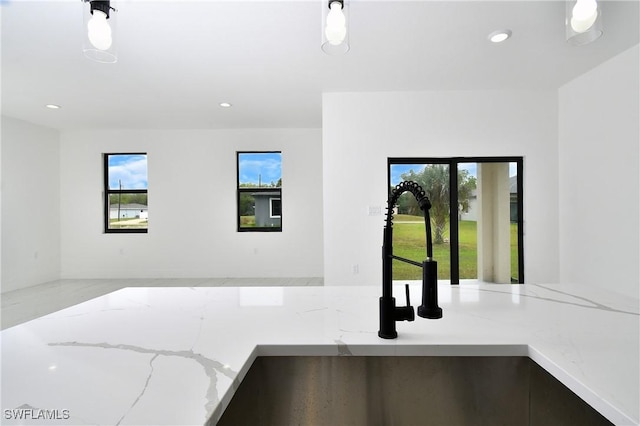 6010 Acorn Cir, Labelle, FL 33935 - kitchen with a sink, open floor plan, light stone counters, recessed lighting, and pendant lighting