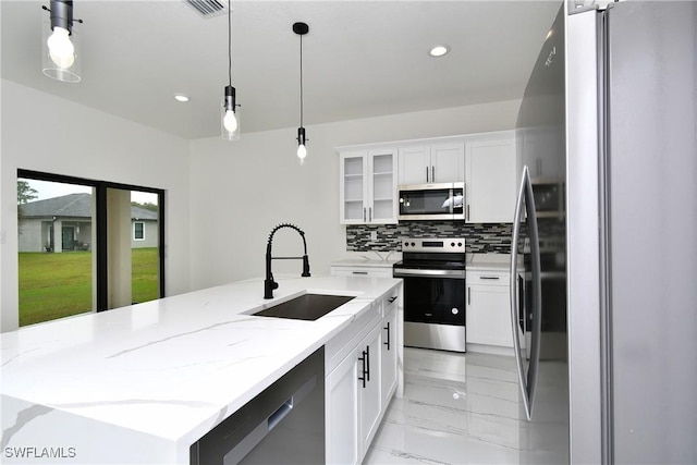 6010 Acorn Cir, Labelle, FL 33935 - kitchen with appliances with stainless steel finishes, a sink, light marble finish flooring, recessed lighting, and hanging light fixtures