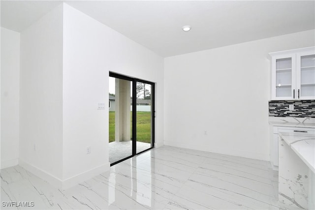 6010 Acorn Cir, Labelle, FL 33935 - unfurnished dining area featuring light marble finish flooring and baseboards
