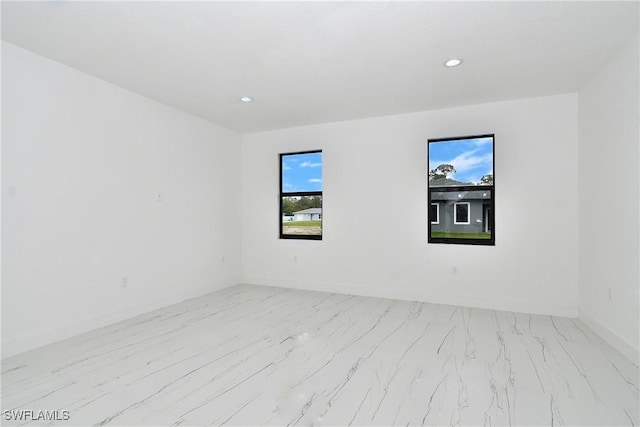 6010 Acorn Cir, Labelle, FL 33935 - unfurnished room with marble finish flooring, recessed lighting, and baseboards