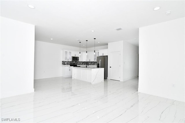 6010 Acorn Cir, Labelle, FL 33935 - kitchen with appliances with stainless steel finishes, recessed lighting, open floor plan, a center island, and white cabinets