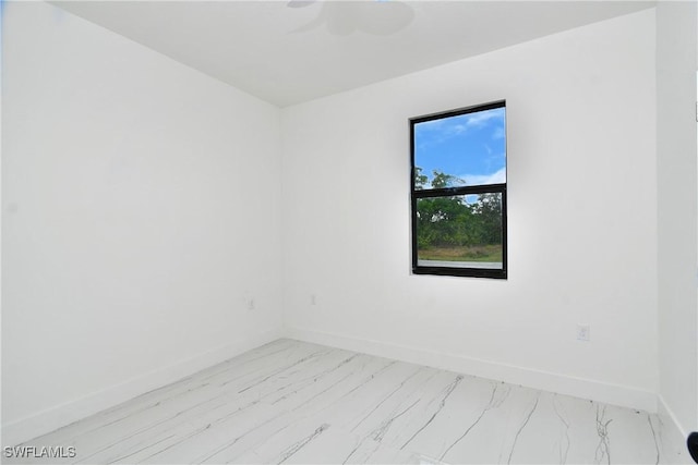 6010 Acorn Cir, Labelle, FL 33935 - spare room with baseboards, light marble finish flooring, and a ceiling fan