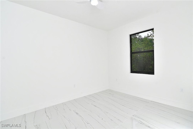 6010 Acorn Cir, Labelle, FL 33935 - empty room featuring marble finish floors, a ceiling fan, and baseboards