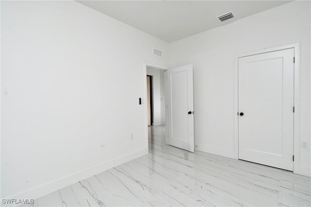 6010 Acorn Cir, Labelle, FL 33935 - unfurnished bedroom featuring light marble finish floors and baseboards