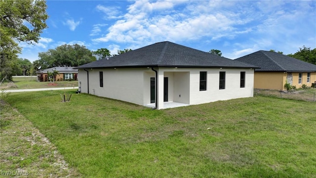 6010 Acorn Cir, Labelle, FL 33935 - back of property featuring a yard and stucco siding