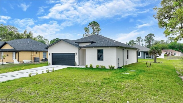6010 Acorn Cir, Labelle, FL 33935 - view of front of home featuring a garage, stucco siding, a front lawn, driveway, and central air condition unit