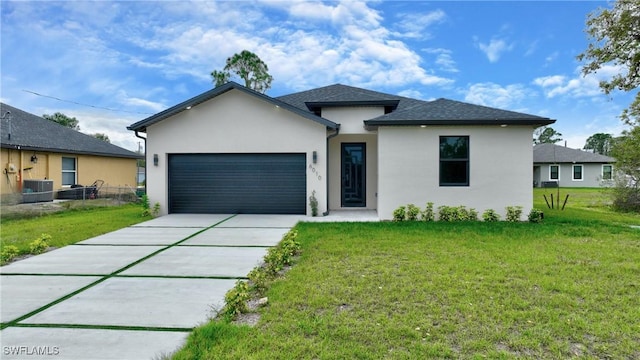 6010 Acorn Cir, Labelle, FL 33935 - view of front of house featuring stucco siding, an attached garage, central AC, and driveway