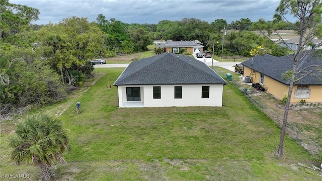 6010 Acorn Cir, Labelle, FL 33935 - rear view of house featuring stucco siding, a shingled roof, and central AC