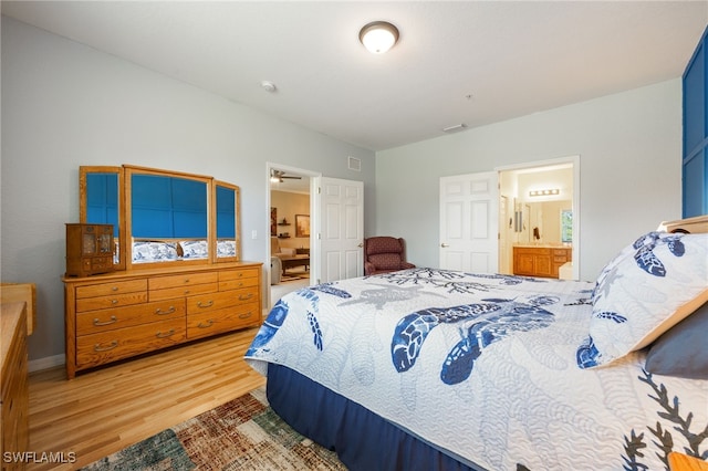14746 Calusa Palms Dr Unit 102, Fort Myers, FL 33919 - bedroom featuring light wood-style floors, connected bathroom, and baseboards