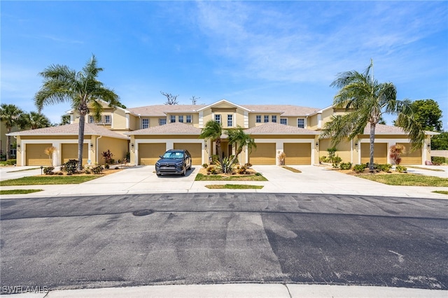 14746 Calusa Palms Dr Unit 102, Fort Myers, FL 33919 - view of front of home featuring driveway, stucco siding, and an attached garage