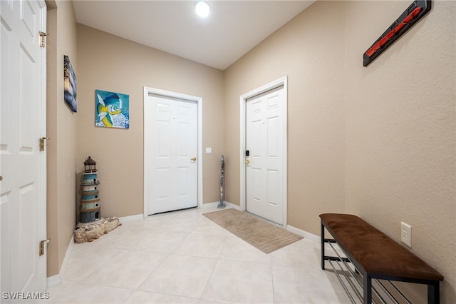 14746 Calusa Palms Dr Unit 102, Fort Myers, FL 33919 - foyer entrance with light tile patterned flooring and baseboards