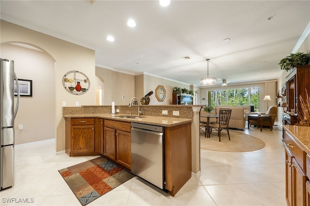 14746 Calusa Palms Dr Unit 102, Fort Myers, FL 33919 - kitchen with stainless steel appliances, arched walkways, brown cabinets, a sink, and light stone countertops