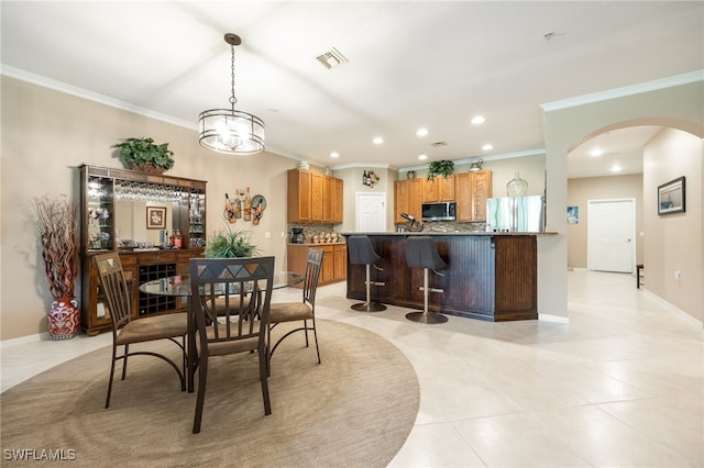 14746 Calusa Palms Dr Unit 102, Fort Myers, FL 33919 - dining room with arched walkways, crown molding, recessed lighting, light tile patterned floors, and baseboards