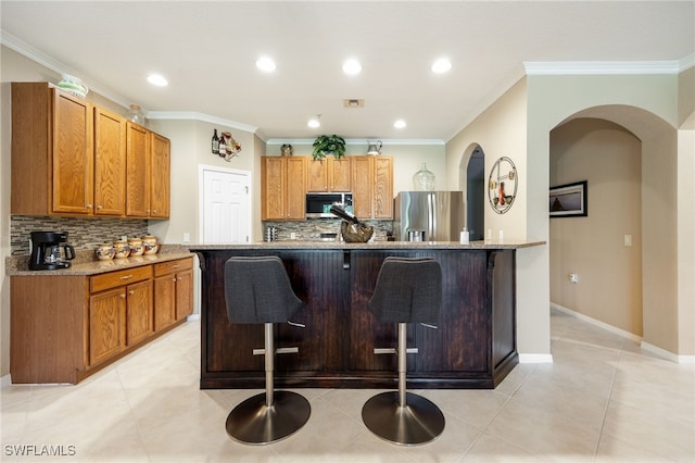 14746 Calusa Palms Dr Unit 102, Fort Myers, FL 33919 - kitchen featuring stainless steel fridge with ice dispenser, a breakfast bar, decorative backsplash, light stone countertops, and ornamental molding