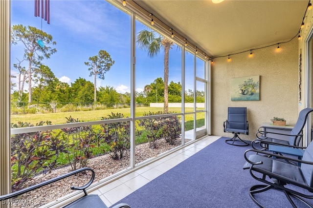 14746 Calusa Palms Dr Unit 102, Fort Myers, FL 33919 - sunroom / solarium with tile patterned flooring, a textured ceiling, and a textured wall