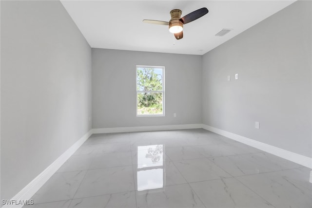 761 Fleming Ave S, Lehigh Acres, FL 33974 - unfurnished room with light marble finish floors, baseboards, and a ceiling fan