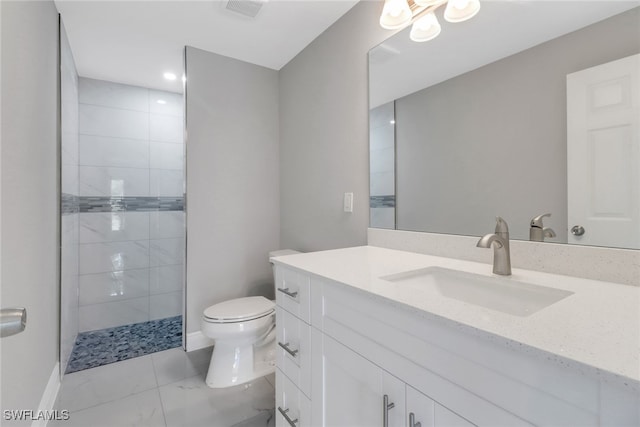 761 Fleming Ave S, Lehigh Acres, FL 33974 - full bathroom with marble finish flooring, toilet, a tile shower, vanity, and baseboards