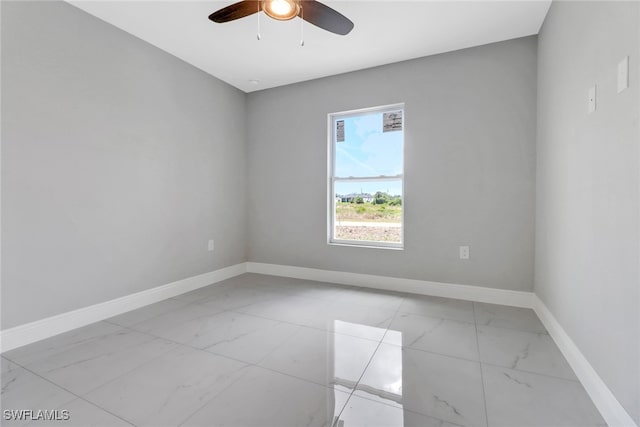 761 Fleming Ave S, Lehigh Acres, FL 33974 - unfurnished room featuring light marble finish flooring, baseboards, and a ceiling fan