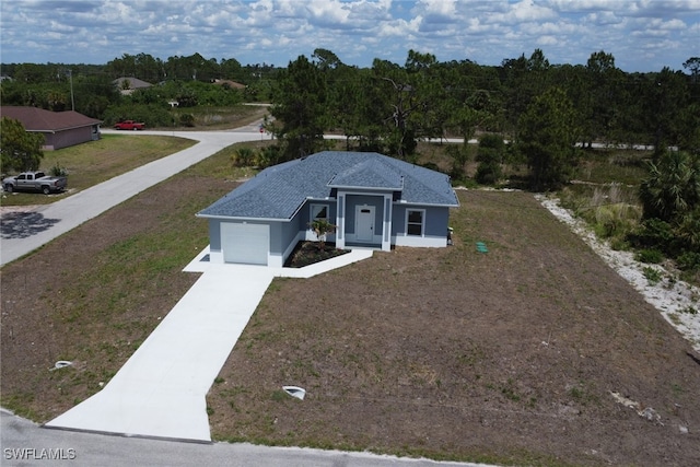 761 Fleming Ave S, Lehigh Acres, FL 33974 - ranch-style house with concrete driveway, an attached garage, stucco siding, and a front lawn