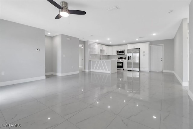 761 Fleming Ave S, Lehigh Acres, FL 33974 - unfurnished living room featuring baseboards, a ceiling fan, light marble finish floors, and recessed lighting
