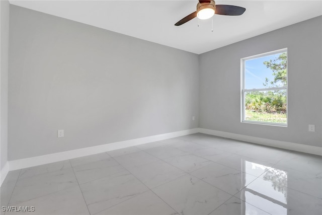 761 Fleming Ave S, Lehigh Acres, FL 33974 - unfurnished room featuring light marble finish flooring, baseboards, and ceiling fan