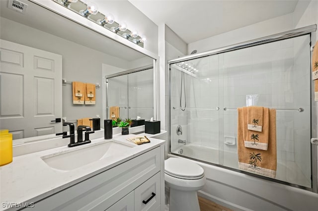 10016 Majestic Ave, Fort Myers, FL 33913 - full bathroom with shower / bath combination with glass door, vanity, toilet, and wood finished floors