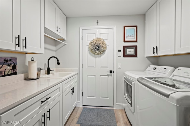 10016 Majestic Ave, Fort Myers, FL 33913 - laundry room featuring separate washer and dryer, cabinet space, and light wood-style floors
