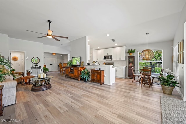 10016 Majestic Ave, Fort Myers, FL 33913 - living room featuring a ceiling fan, light wood-style floors, a chandelier, recessed lighting, and vaulted ceiling