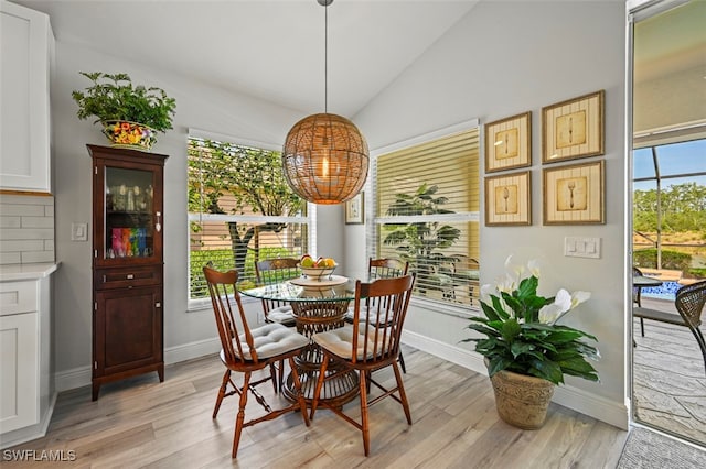 10016 Majestic Ave, Fort Myers, FL 33913 - dining area featuring a chandelier, light wood finished floors, lofted ceiling, and baseboards
