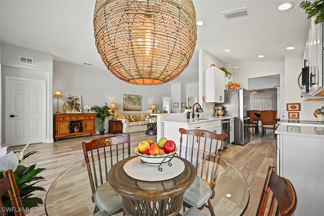 10016 Majestic Ave, Fort Myers, FL 33913 - dining space featuring light wood-type flooring, recessed lighting, and lofted ceiling