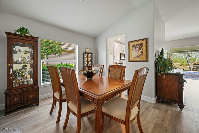 10016 Majestic Ave, Fort Myers, FL 33913 - dining room featuring vaulted ceiling, light wood finished floors, and baseboards