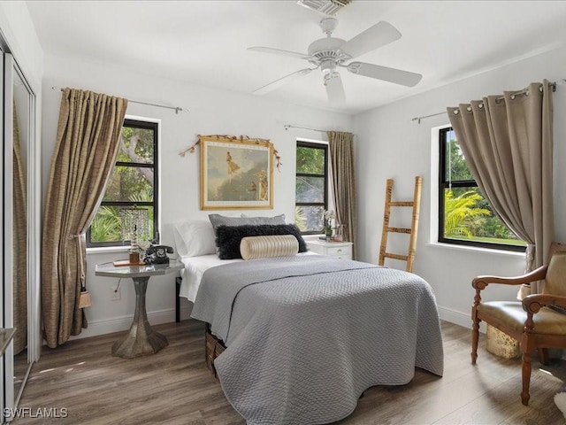 20697 Charing Cross Cir, Estero, FL 33928 - bedroom featuring multiple windows, wood finished floors, and baseboards