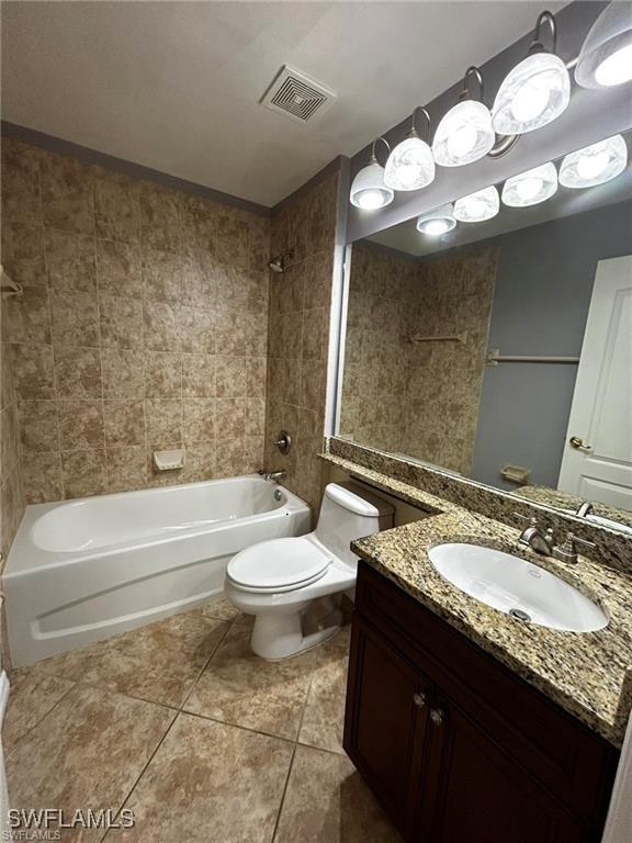 13000 Sandy Key Bnd Unit 3202, North Fort Myers, FL 33903 - bathroom featuring shower / bathtub combination, tile patterned flooring, toilet, and vanity
