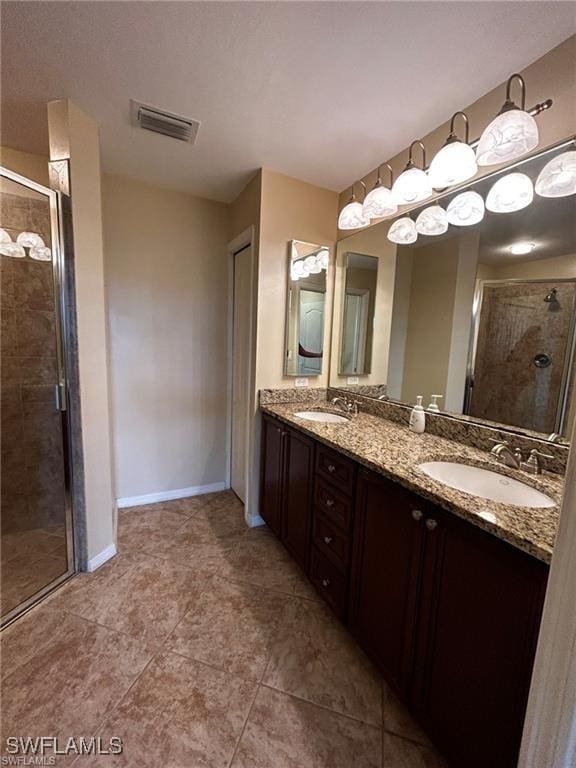 13000 Sandy Key Bnd Unit 3202, North Fort Myers, FL 33903 - full bathroom with a shower stall, baseboards, double vanity, and tile patterned floors