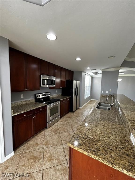 13000 Sandy Key Bnd Unit 3202, North Fort Myers, FL 33903 - kitchen with appliances with stainless steel finishes, a sink, light tile patterned floors, baseboards, and recessed lighting