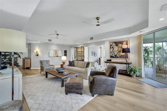 591 Audubon Blvd Unit B202, Naples, FL 34110 - living room featuring a ceiling fan, a tray ceiling, light wood-style floors, and recessed lighting