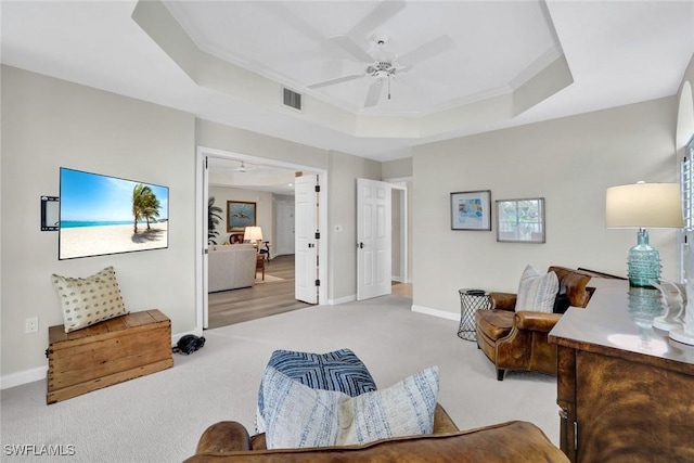 591 Audubon Blvd Unit B202, Naples, FL 34110 - living room featuring carpet, a tray ceiling, and ceiling fan