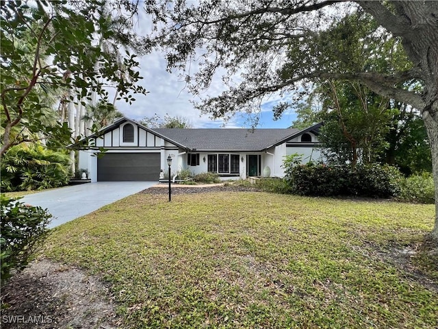 12483 Afton Ct, Fort Myers, FL 33908 - view of front of property featuring an attached garage, driveway, and a front lawn