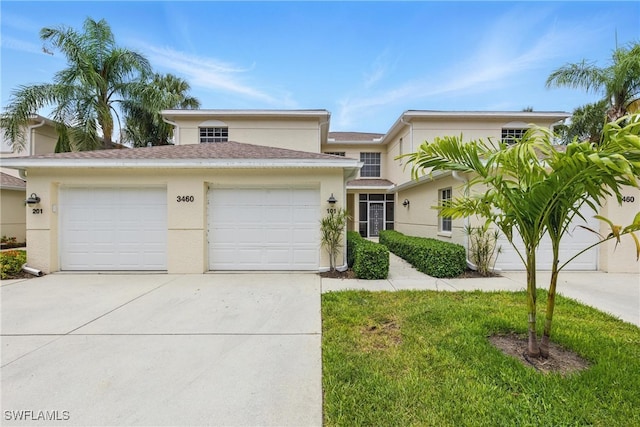 3460 W Crown Pointe Blvd Unit 101, Naples, FL 34112 - view of front of property with concrete driveway, stucco siding, and an attached garage