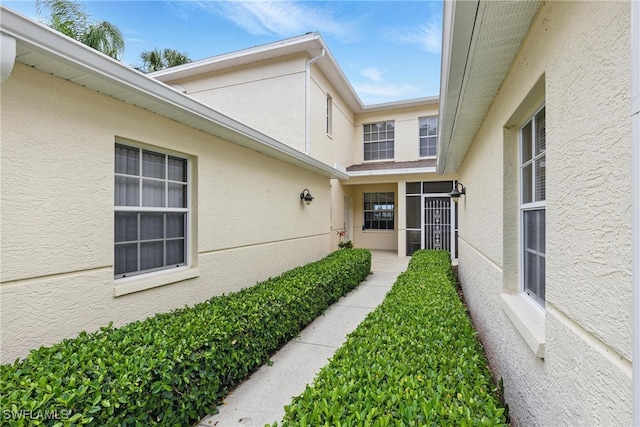 3460 W Crown Pointe Blvd Unit 101, Naples, FL 34112 - doorway to property with stucco siding