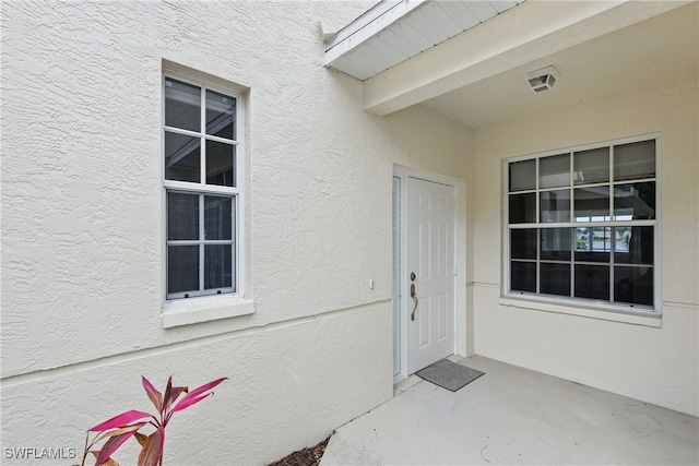 3460 W Crown Pointe Blvd Unit 101, Naples, FL 34112 - doorway to property with stucco siding