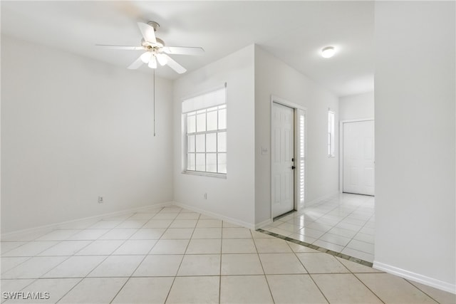 3460 W Crown Pointe Blvd Unit 101, Naples, FL 34112 - spare room with light tile patterned flooring, ceiling fan, and baseboards