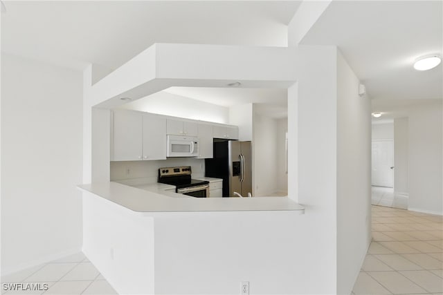 3460 W Crown Pointe Blvd Unit 101, Naples, FL 34112 - kitchen featuring stainless steel appliances, light tile patterned flooring, and light countertops