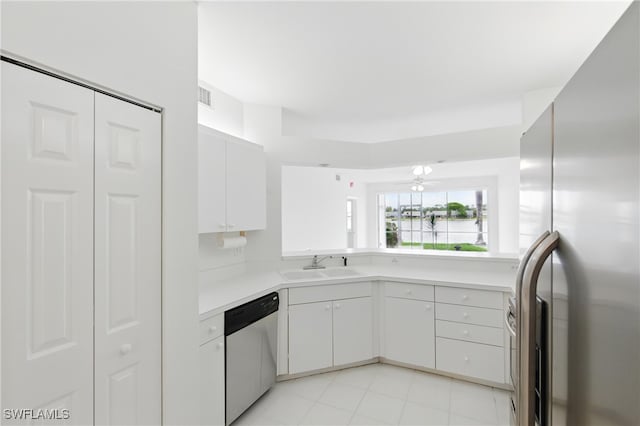 3460 W Crown Pointe Blvd Unit 101, Naples, FL 34112 - kitchen with appliances with stainless steel finishes, a sink, light countertops, white cabinets, and light tile patterned floors
